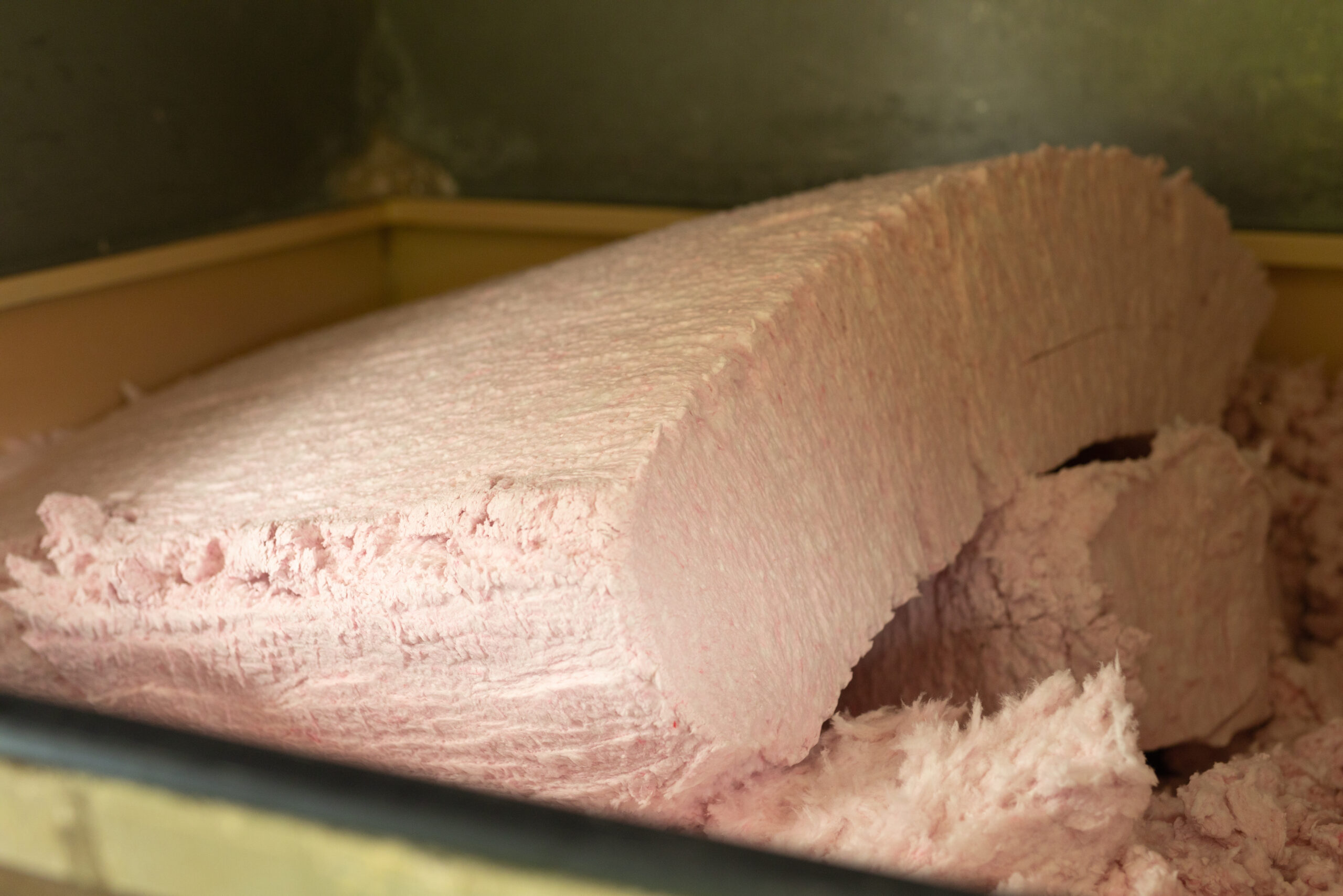 Exposed pink fiberglass batt insulation