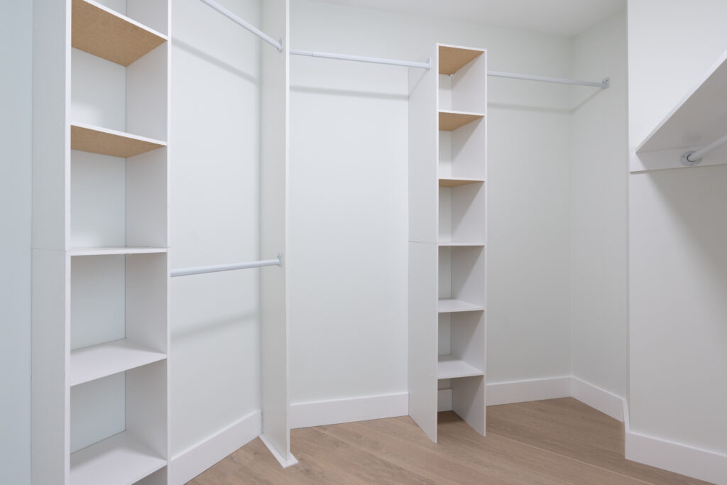 Detail of primary walk in closet with built in shelving.
