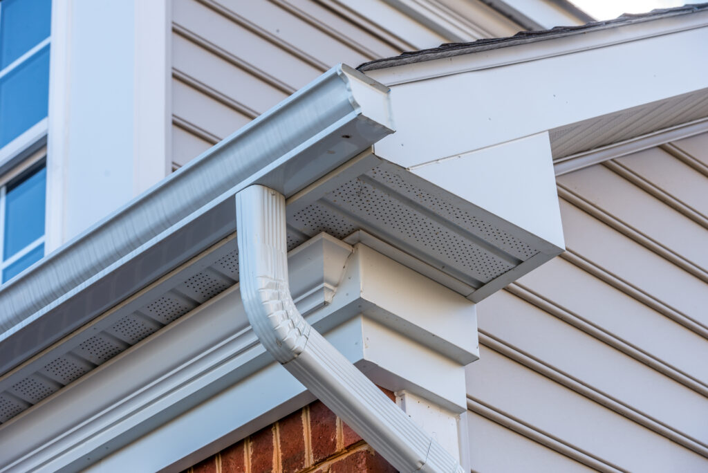 a close up of futters and a downspout on a house.