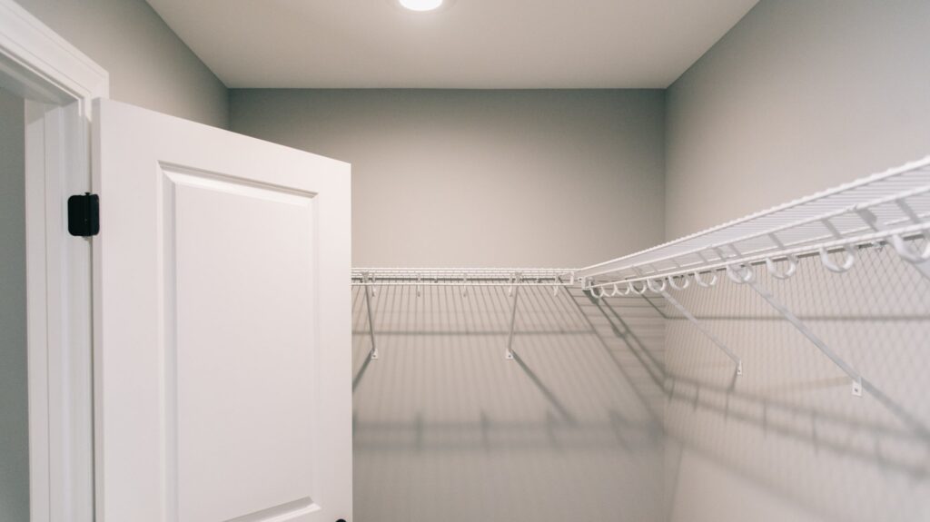 Empty closet with white shelving